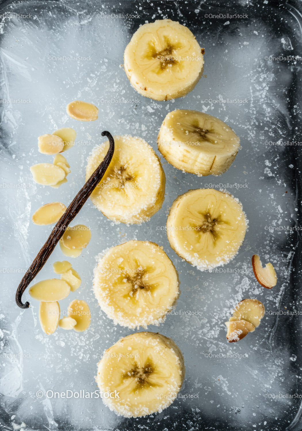 Frozen banana slices with vanilla and almond flakes on ice