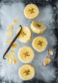 Frozen banana slices with vanilla and almond flakes on ice