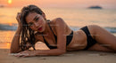 Elegant Woman in Black Bikini Lying on Beach at Sunset