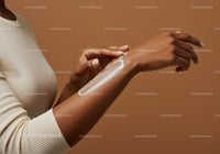 Close-up of Woman Applying Sunscreen Lotion to Arm for Sun Protection