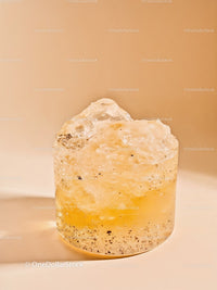Close-up of translucent yellow mineral stone on beige background