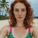 Freckled Woman Enjoying a Sunny Beach Day