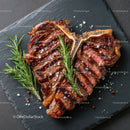 Juicy Grilled Ribeye Steak with Herbs on Black Slate Plate
