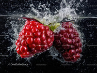 Fresh Red Raspberries Splashing into Water with Burst of Juiciness