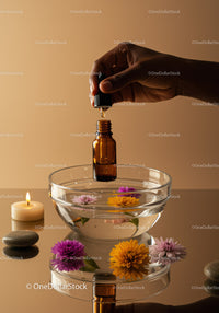 Amber Glass Bottle with Dropper Over Bowl of Flowers in Relaxing Spa Scene