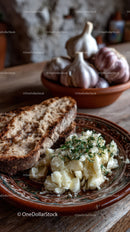 Rustic Garlic Bulbs, Bread and Mashed Potatoes with Herbs in a Cozy Kitchen
