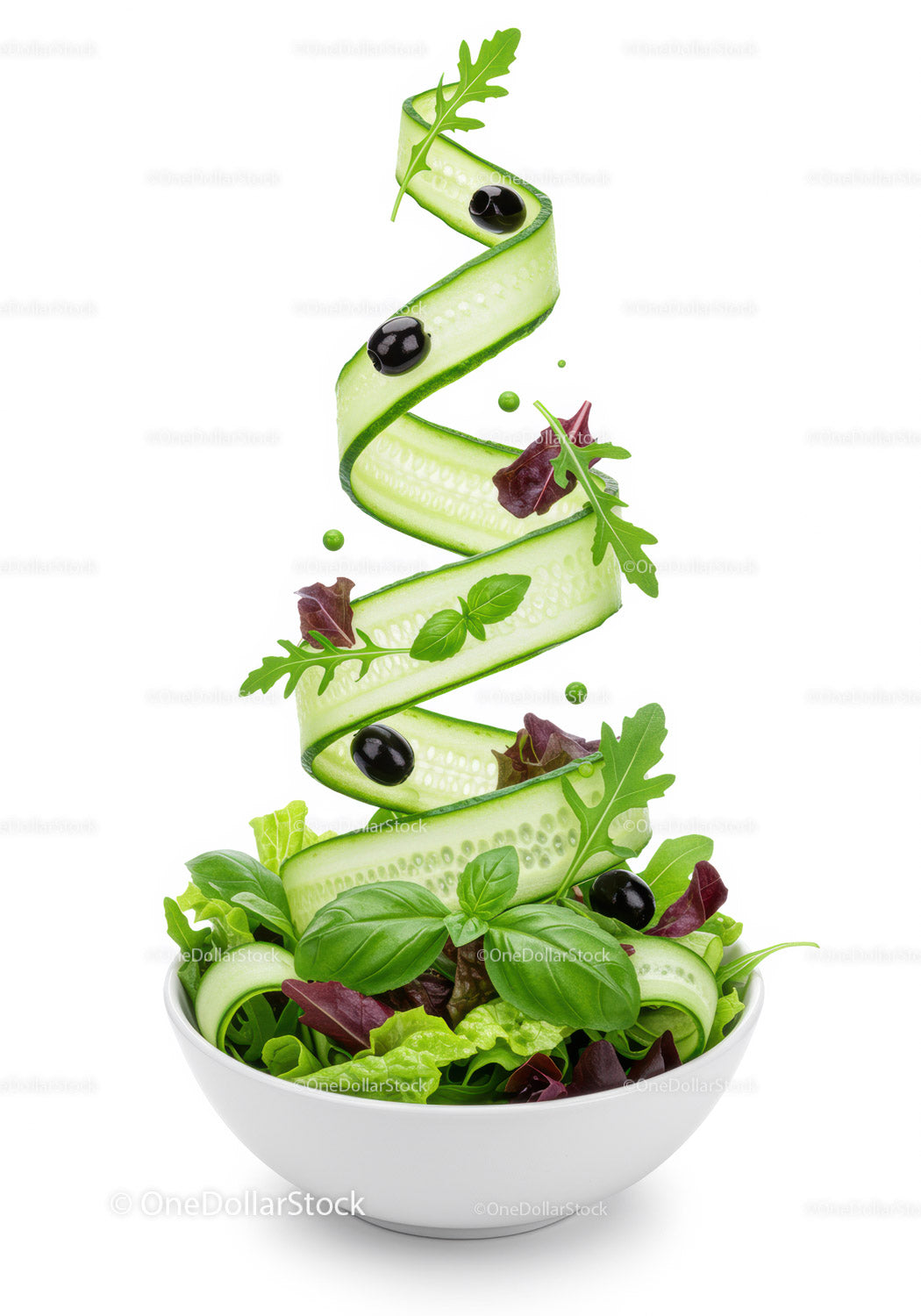 Fresh green salad with cucumber ribbons and olives