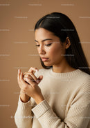 Elegant Woman in Cozy Sweater with Serene Expression and Dark Hair