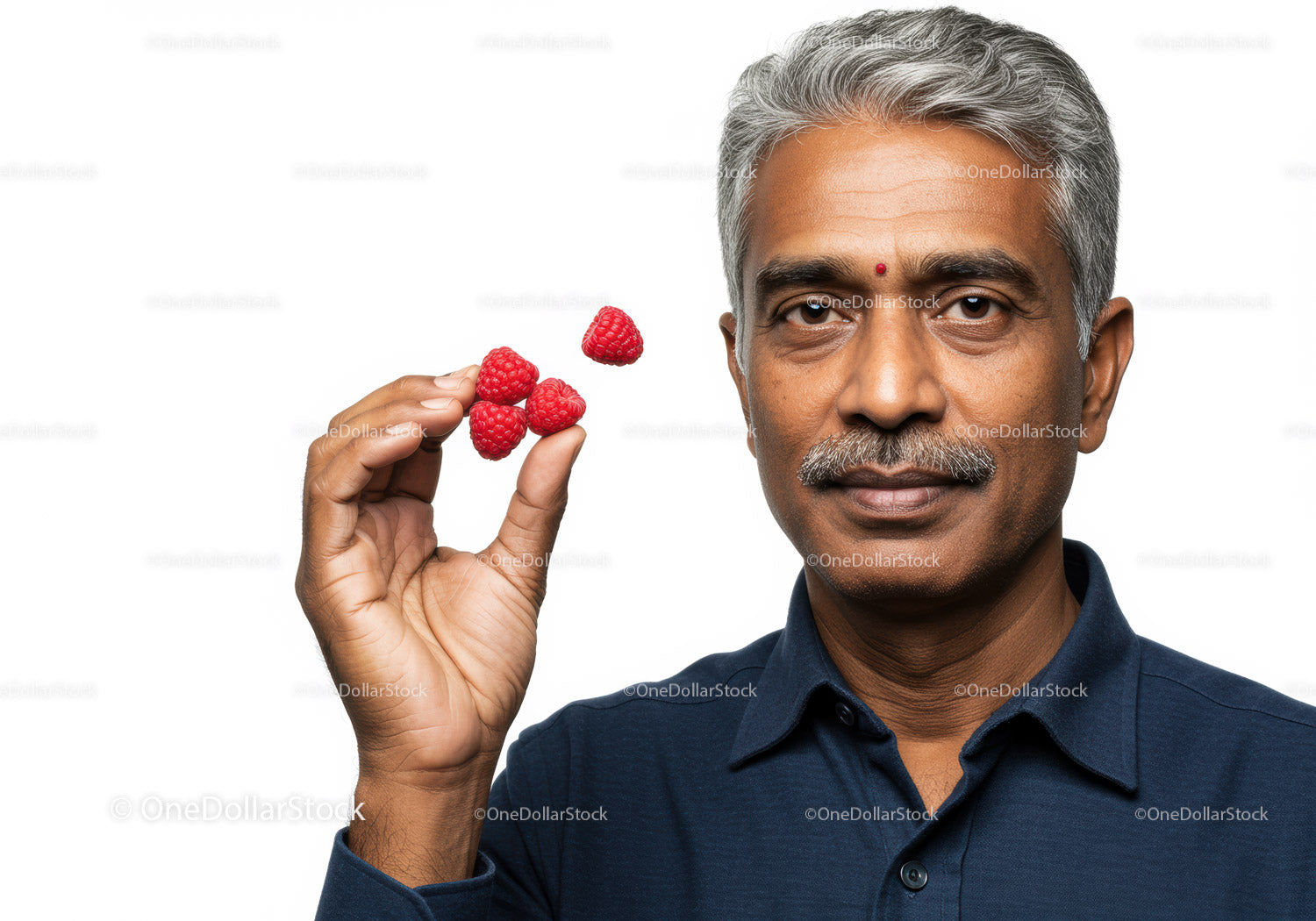 Elderly Man Enjoying Fresh Raspberries for Healthy Living