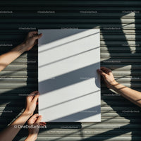 Hands Holding Blank Poster With Shadow Patterns