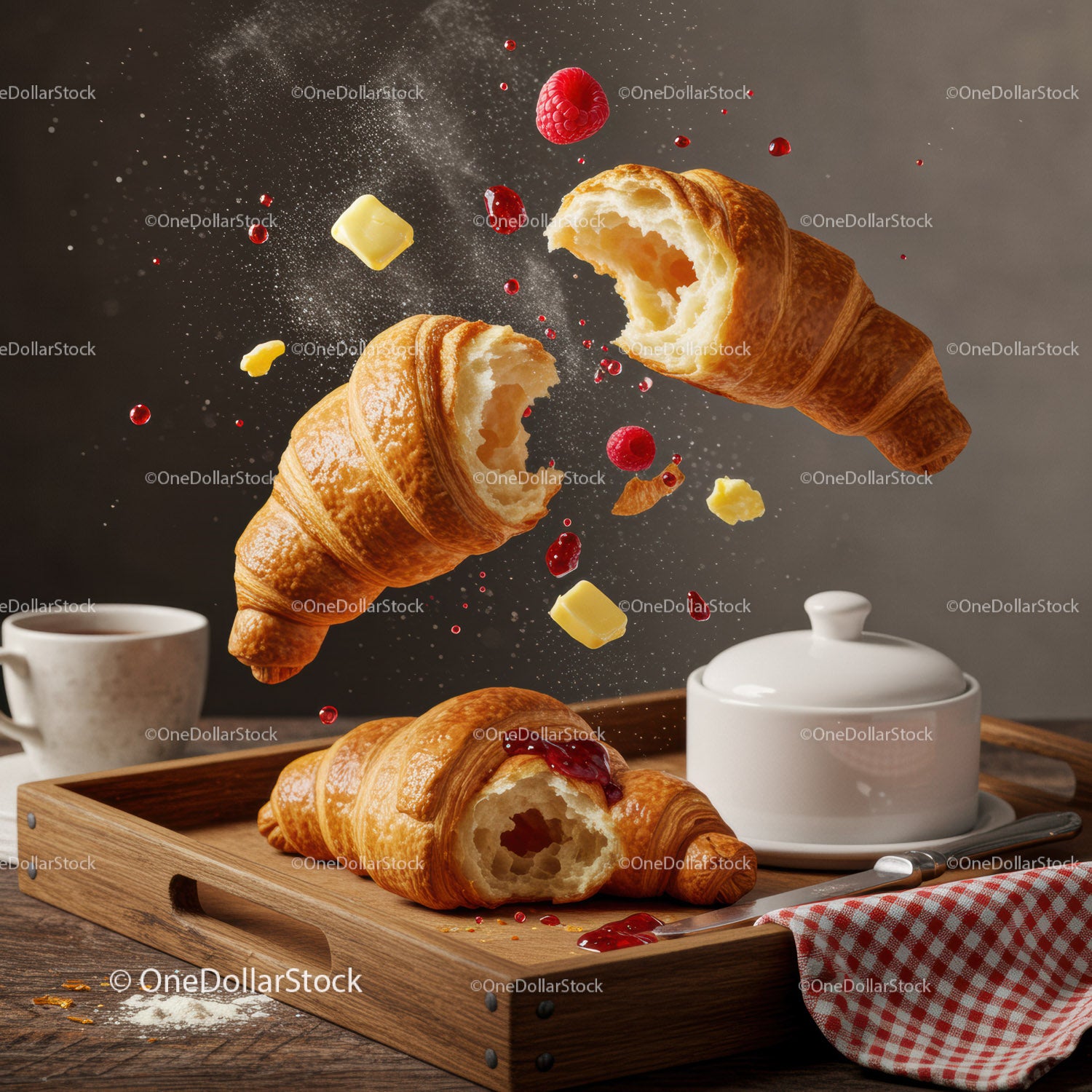 Fresh croissants with butter and raspberry jam on tray