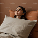 Relaxed Woman Lounging with Pillow in Cozy Bedroom Scene