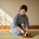 Woman in Traditional Yukata Serving Japanese Rice Ball