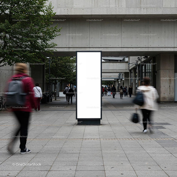 Blank vertical billboard in busy urban pedestrian area JPG Mockup Image