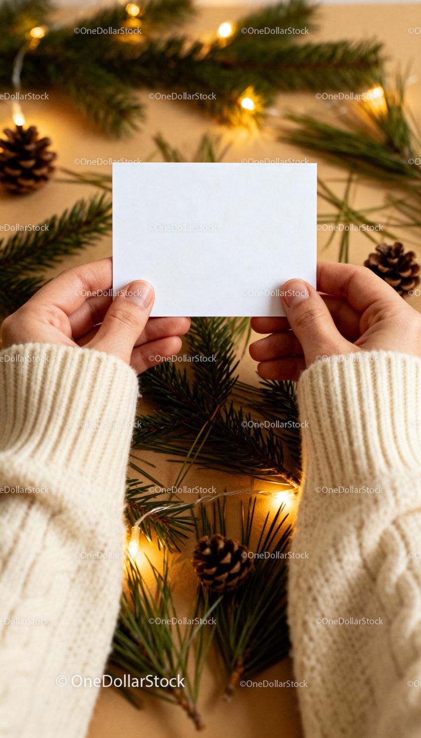 Hands Holding Blank Card with Fir and Pinecone Decoration JPG Mockup Image preview