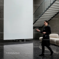 Blurred woman walking in modern minimalistic lobby