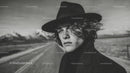 Black and White Portrait of Man with Black Hat in Mountain Landscape