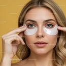 Young woman applying eye patches for skincare routine