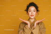 Portrait of a Smiling Freckled Woman with Curly Hair on Yellow Background