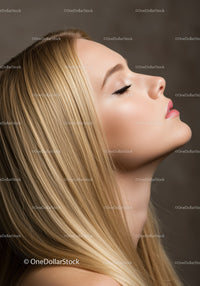 Profile of peaceful woman with closed eyes and long blonde hair