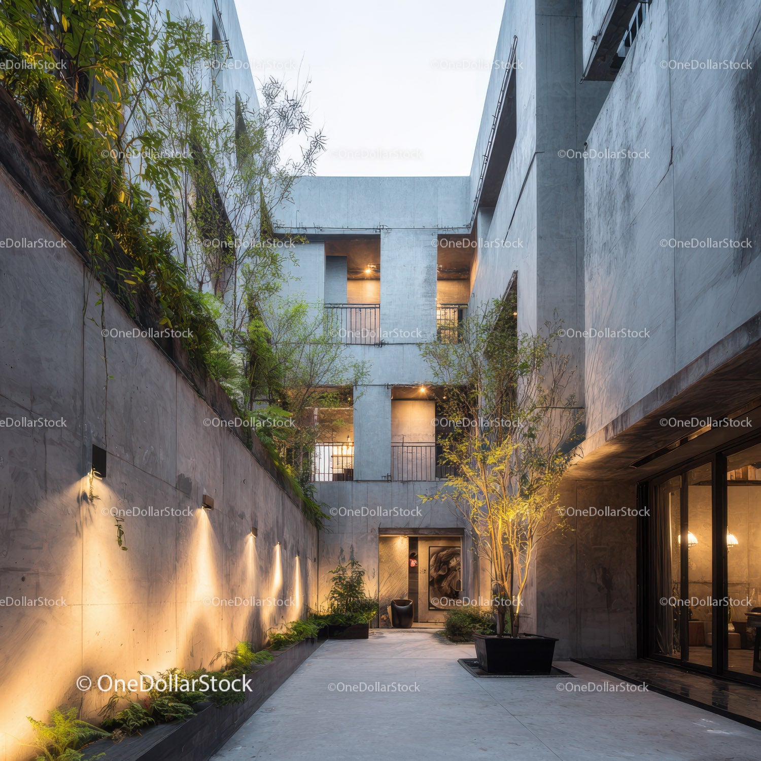 Modern Concrete Building with Lush Courtyard and Ambient Lighting