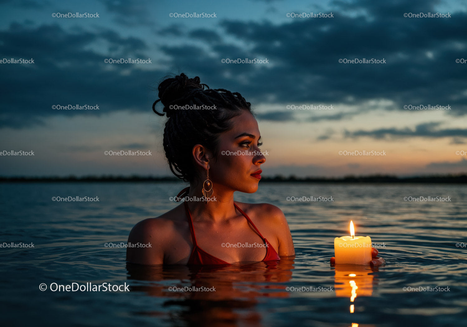 Woman in Black Bikini with Candles Floating in Lake at Sunset
