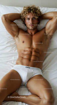 Fit young man relaxing on bed in white briefs