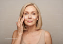 Mature Woman Applying Skincare Lotion with Confidence