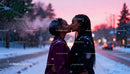 Couple Sharing Tender Kiss on Snowy Winter Evening