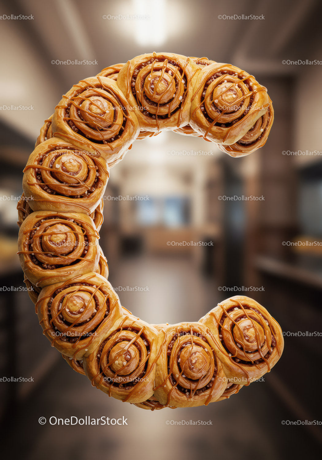 Golden cinnamon rolls arranged in letter C shape