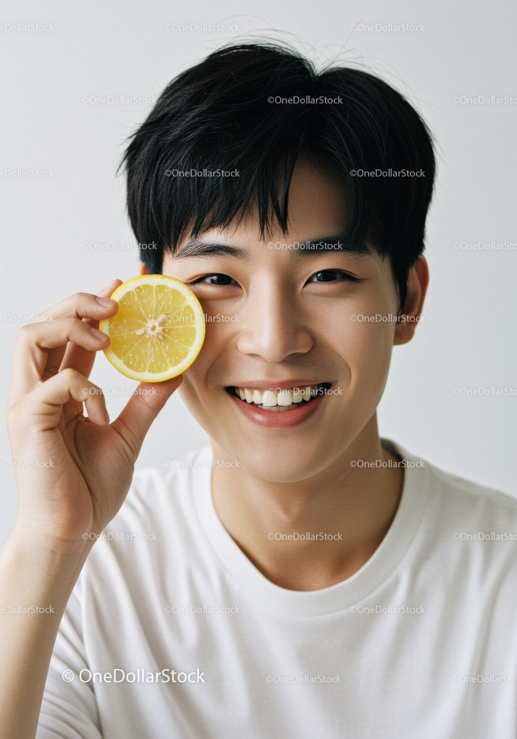 Young Man Smiling Holding Lemon Slice Bright Portrait