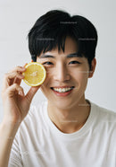 Young Man Smiling Holding Lemon Slice Bright Portrait