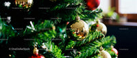 Close-up of Christmas tree with shiny golden baubles