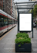 Modern tram station with empty advertising poster in city