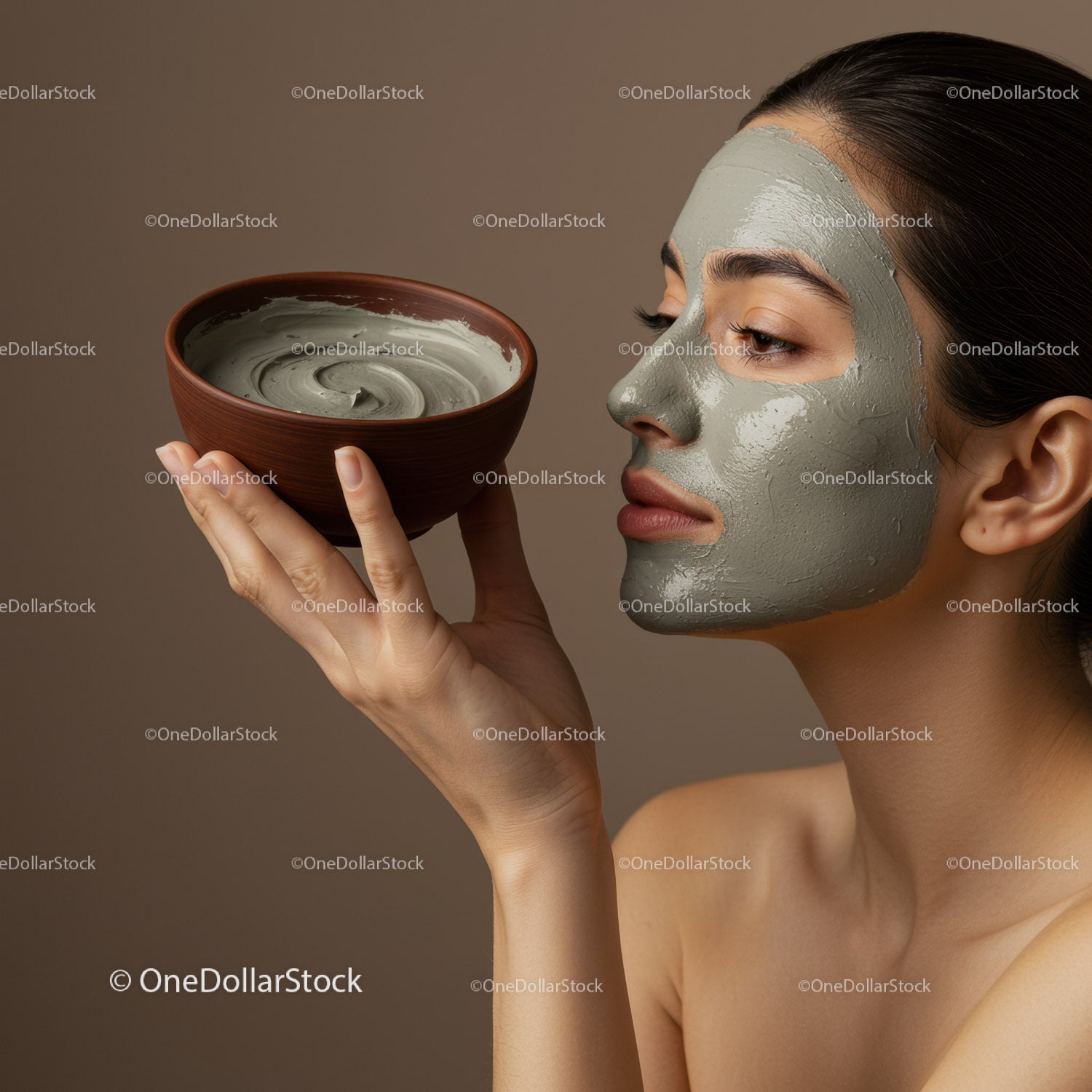 Woman Applying Clay Face Mask During Spa Treatment