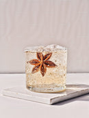 Refreshing cocktail with star anise garnish and ice cubes