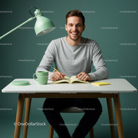 Smiling Young Man at a Modern Desk with Green Accents