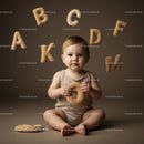 Baby Playing with Soft Alphabet Letters in Neutral Tones