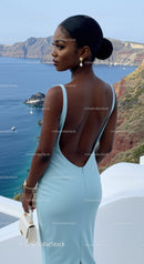 Elegant woman in blue dress overlooking ocean cliffs