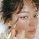 Close-up of Woman Applying Eye Makeup with Brush