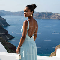 Elegant woman in blue dress overlooking serene sea view