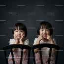 Two Happy Girls with Joyful Expressions Sitting Together