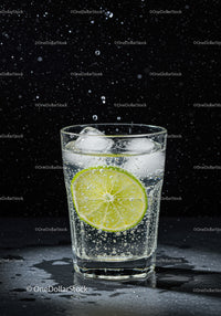 Refreshing sparkling water with lime and ice cubes