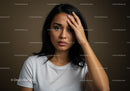 Expressive Portrait of a Thoughtful Woman with Dark Hair and White T-Shirt
