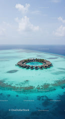 Overwater Bungalows in Turquoise Ocean With Clear Blue Sky