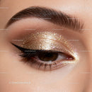 Close-up of eye with shimmering golden glitter makeup