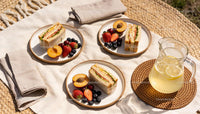 Casual Outdoor Picnic with Sandwiches and Fresh Fruits