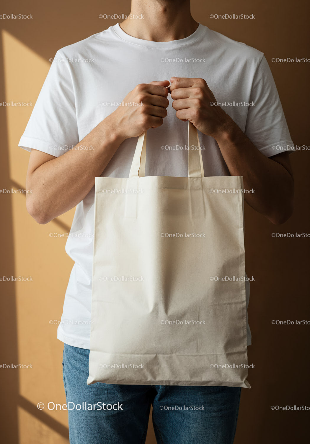 Man holding blank cotton tote bag in natural light