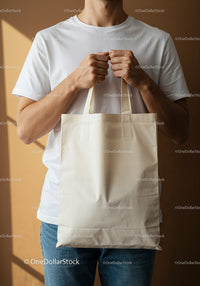 Man holding blank cotton tote bag in natural light
