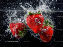 Fresh Red Strawberries Splashing into Water in Macro Shot